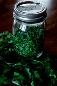 A bundle of healthy fresh parsley and a jar of dried parsley