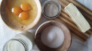 Fresh Eggs cracked, sugar, salt, milk, butter and yeast. Ingredients for homemade Braided Egg Bread